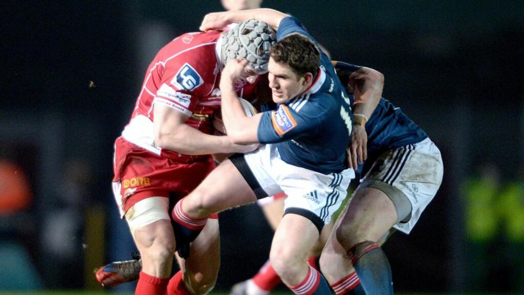 Jonathan Davies of Scarlets is tackled by Ian Keatley of Munster in Saturday’s close-fought encounter. Photograph: Huw Evans/Inpho
