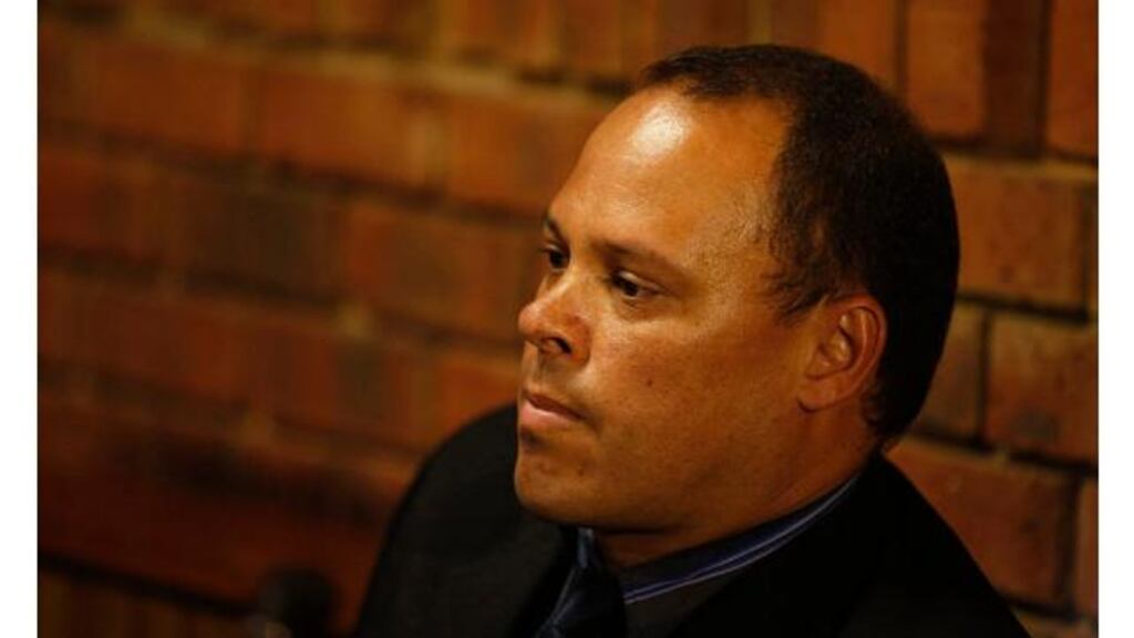 Hilton Botha, the lead detective in the Oscar Pistorius murder case, sits in court today. Botha is himself facing attempted murder charges for firing on a minibus full of passengers, South African police said. Photograph: Mike Hutchings/Reuters