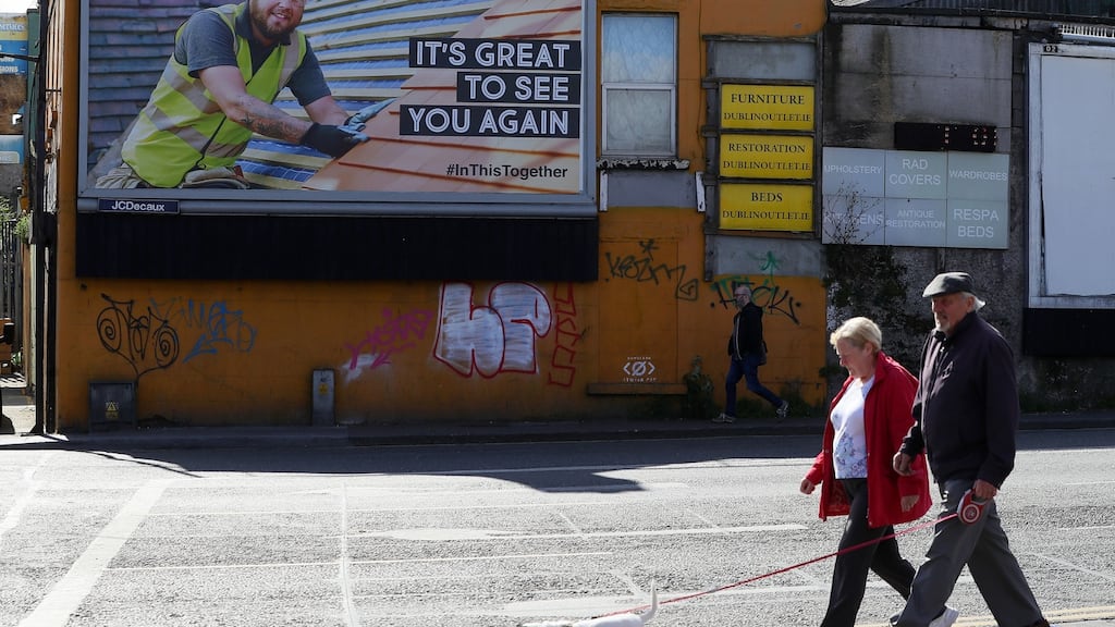 People walk past a billboard in Dublin which is part of the Government’s In This Together campaign. Governments around the world are starting to worry about how to keep the public onside during the long, divisive, fretful months ahead. Photograph: Brian Lawless/PA Wire