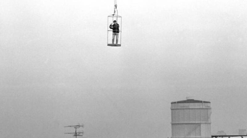 Matt Kavanagh took this hair-raising photo of Tom Lawlor dangling from the crane while taking the first photo