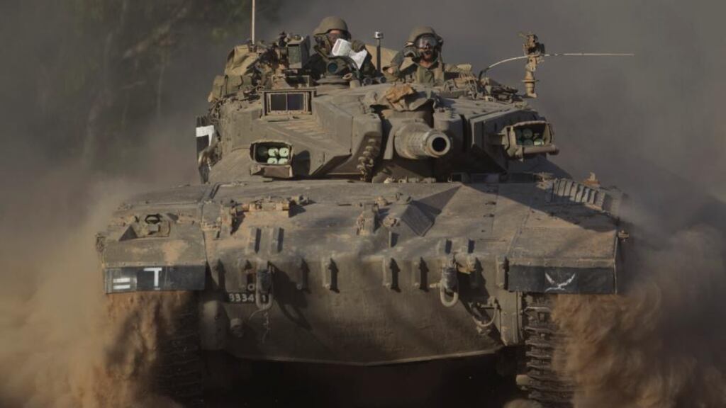 Soldiers drive a tank to a position near the border with Gaza yesterday as Israel contemplates a ground invasion. Photograph: Ariel Schalit/AP