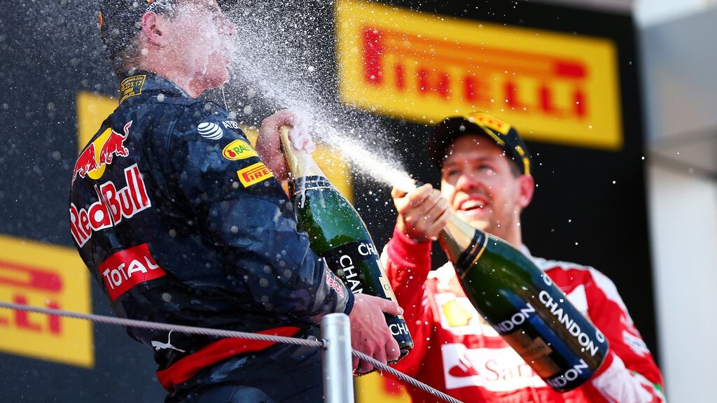 Max Verstappen of Netherlands and Red Bull Racing celebrates his first win on the podium with Sebastian Vettel of Germany and Ferrari during the Spanish Formula One Grand Prix at Circuit de Catalunya. Photograph: Dan Istitene/Getty Images
