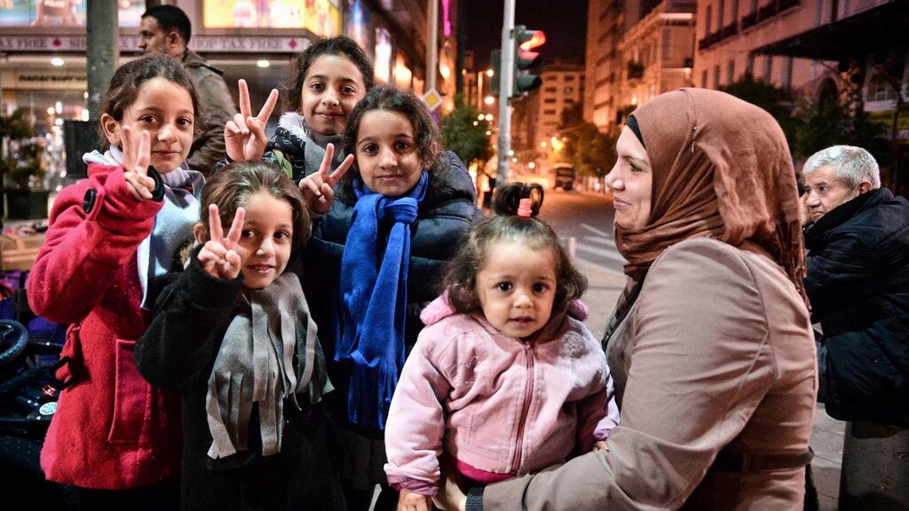 Children waiting for a bus to Athens airport to take a special charter flight to France. Photograph: Louisa Gouliamaki/AFP/Getty Images