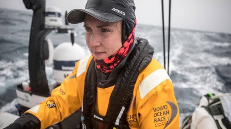 Annalise Murphy steers the boat as it passes Tristan da Cunha in the mid Atlantic. Photo: Sam Greenfield/Volvo Ocean Race