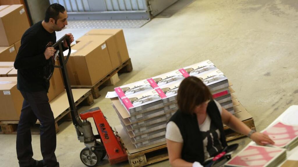 An employee packages vinyl albums as another pushes a dolly holding a pallet full of completed and packaged records, ready for shipment, at the Optimal record plant   in Roebel, Germany. Photoraph: Adam Berry/Getty Images)