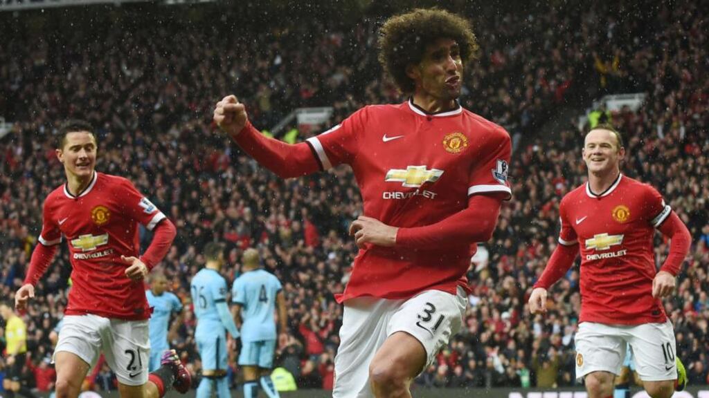 Marouane Fellaini celebrates scoring Manchester United’s second goal in their victory over Manchester City. Photograph: Paul Ellis/AFP Photo
