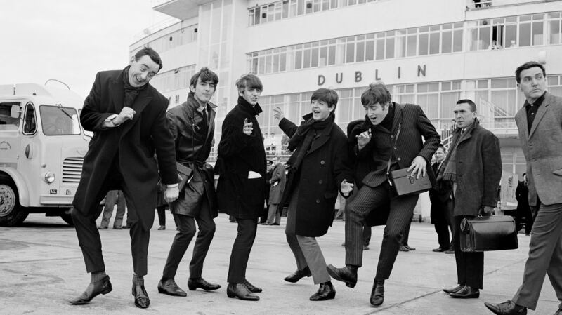 The Beatles arrive in Ireland to play their two concerts in the Adelphi cinema on November 7th, 1963. Alongside them is radio and TV personality Paul Russell (left), with Frank Hall on the right. Photograph: Lensmen/Irish Photo Archive