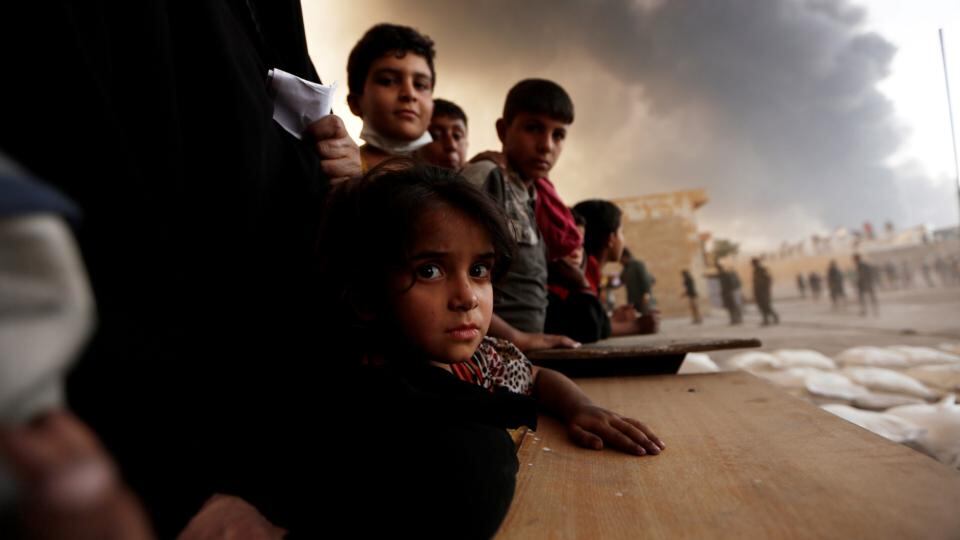 Displaced children wait to receive food supplies at a processing centre in Qayyara, south of Mosul. Photograph: Zohra Bensemra/Reuters