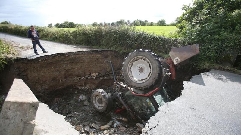 Inishowen floods: a tractor sits in a river after a road collapsed in Co Donegal this month. Photograph: Niall Carson/PA