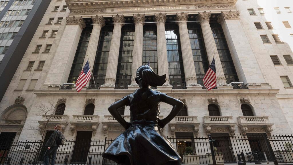 The New York Stock Exchange at Wall Street and the ‘Fearless Girl’ statue in New York City. Photograph: Angela Weiss/AFP via Getty Images