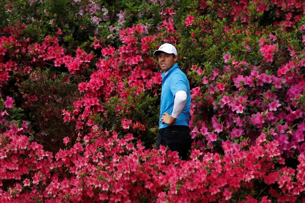 Rory McIlroy looks back at the green while hitting out from amid the azaleas on the 13th hole during the third round of the 2018 Masters. Photograph: Mike Segar/Reuters
