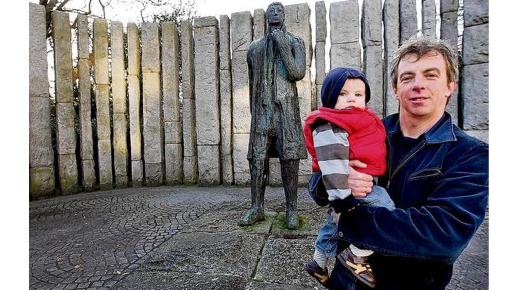 Eamon Delaney with his 16-months-old son, Ciaran, at the Wolfe Tone sculpture by his father Edward Delaney, on St Stephen's Green, Dublin. Photograph by Eric Luke