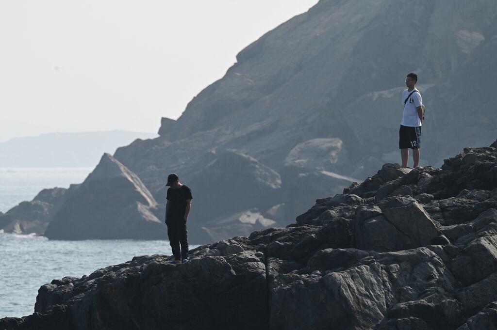 Two men look out over the Taiwan Strait, from a harbour on Pingtan island, the closest point in China to Taiwan, in China's southeast Fujian province. Photograph: Greg Baker/Getty Images