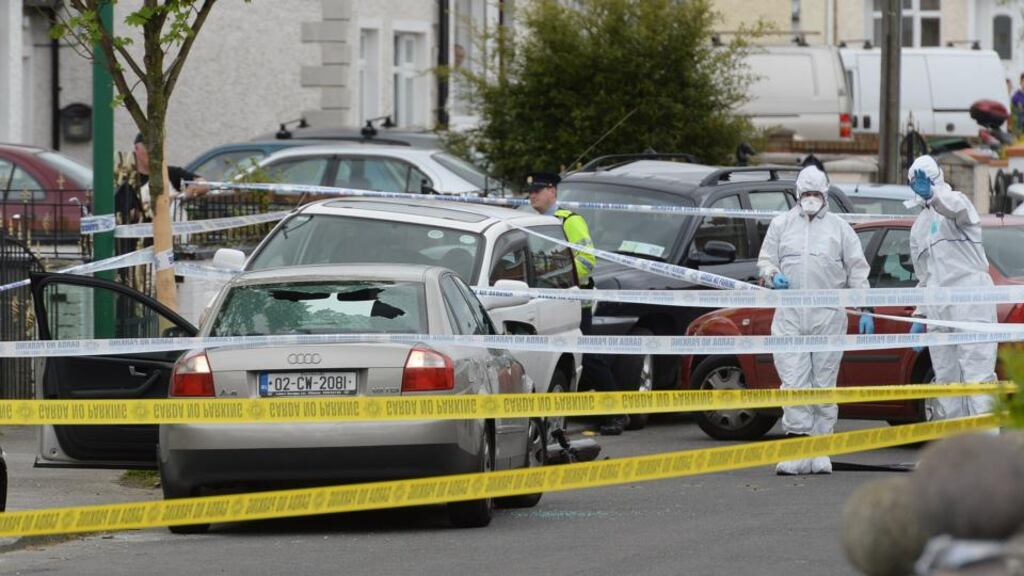 Forensics gardaí examine the scene of the murder of Christopher Zambra at Cooley Road in Drimnagh yesterday. Photograph: Cyril Byrne