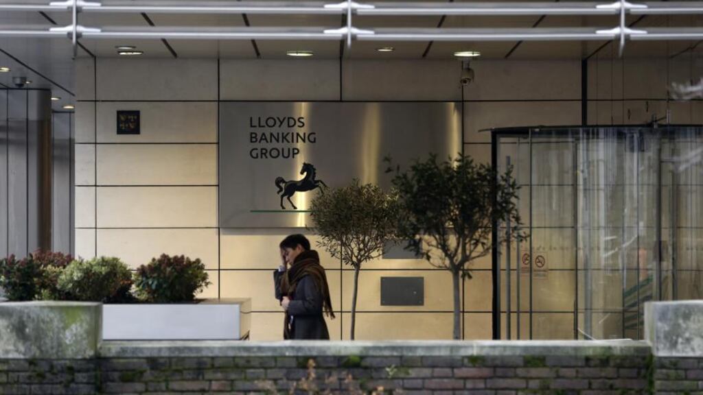 A visitor exits the headquarters of Lloyds Banking Group in London. The UK government has sold a £4.2 billion (€5 billion) stake in Lloyds. Photo: Bloomberg