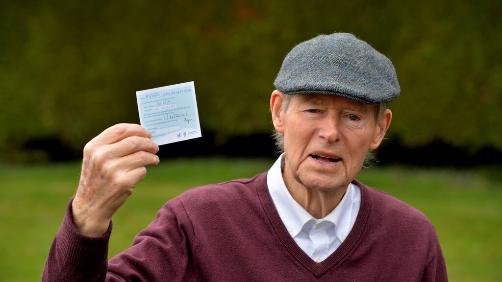 Retired sports commentator Mícheál Ó Muircheartaigh with his HSE vaccine card: he received his first injection at the Blanchardstown Primary Care Centre on Thursday. Photograph: Alan Betson