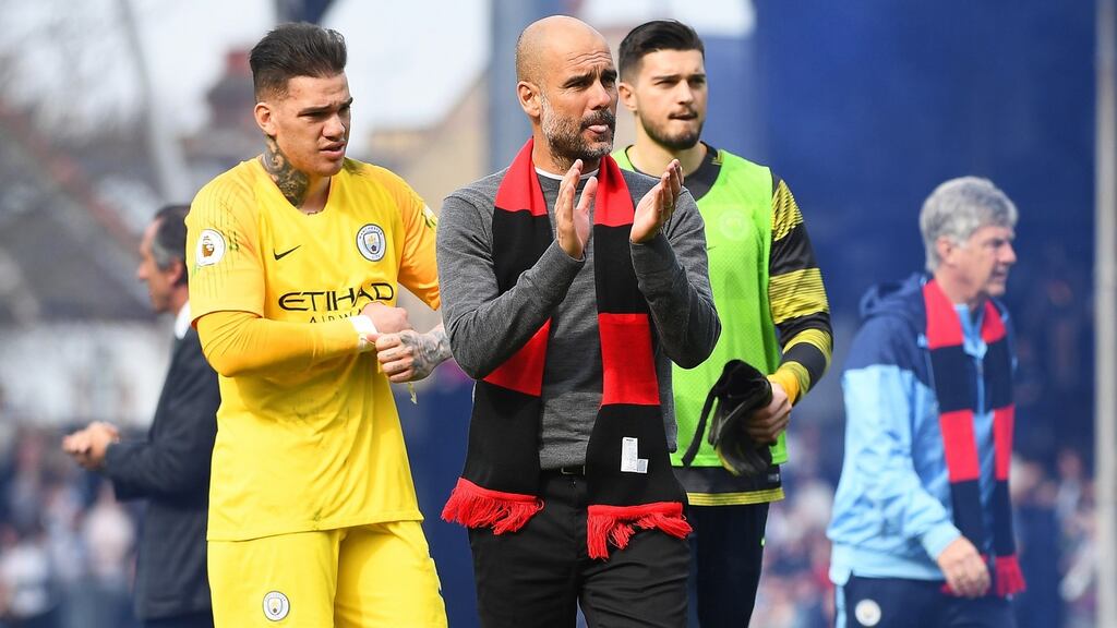 Manchester City’s manager Pep Guardiola and goalkeeper Ederson react after beating Fulham 2-0 at Craven Cottage on Saturday. Photograph: EPA