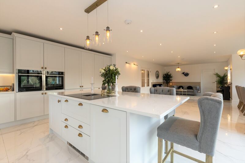 To the rear is the hub of the home: a spacious open-plan living/kitchen/dining area that makes the most of its southerly aspect through lots of glazing.