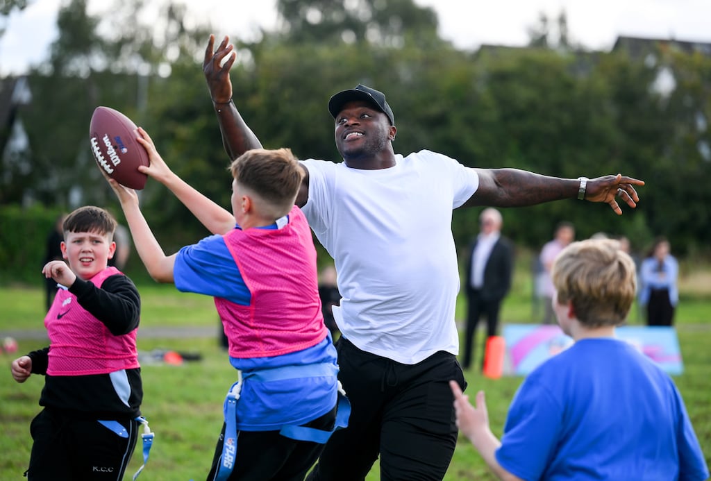 NFL player Efe Obada with students from Kingswood Community College in Dublin during an NFL flag football clinic. Photograph: Brendan Moran/Sportsfile