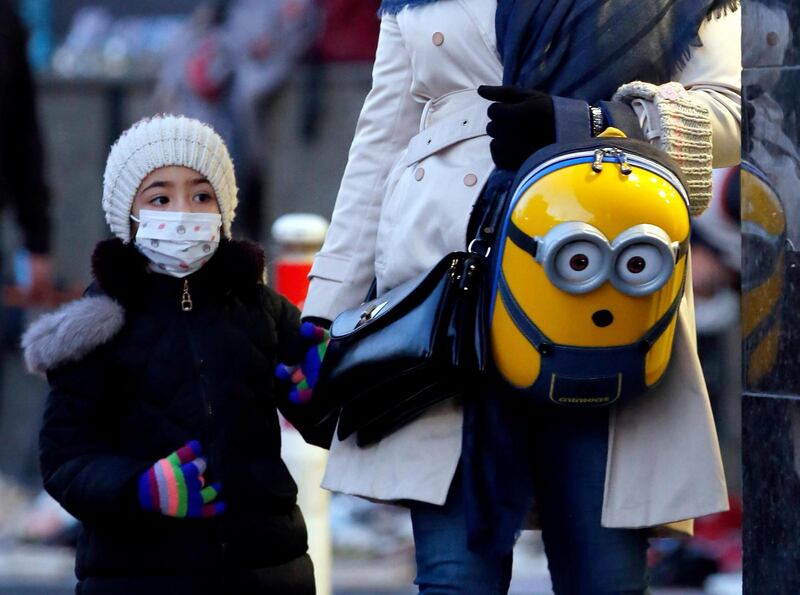An Iranian child wears a face mask while walking on a street in Tehran, Iran on Saturday. Photograph: Abedin Taherkenareh/EPA