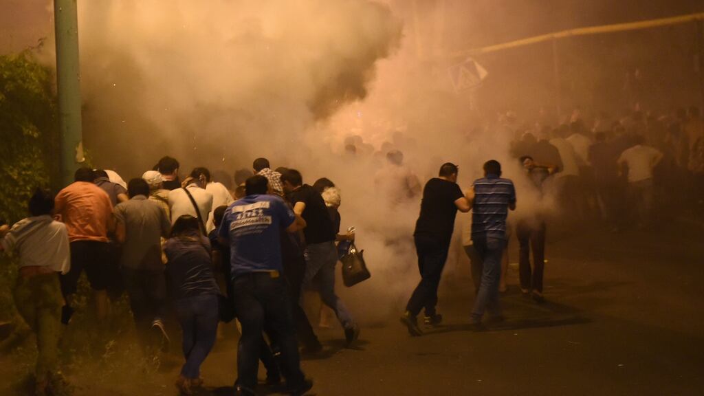 Armenian police clashing with protesters in Yerevan, Armenia, on Friday. Scores of protesters were injured and more than 100 detained when police used truncheons and stun grenades against a march of several thousand people. Photograph: Vahram Baghdasaryan/EPA