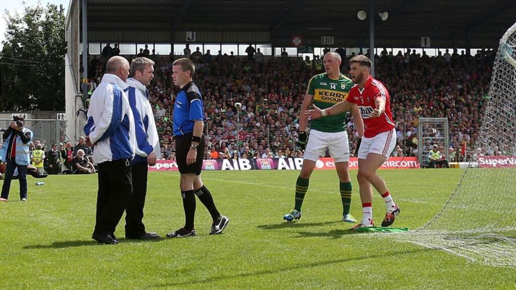 Referee Pádraig Hughes consults with his umpires before awarding a penalty to Kerry. Photograph: Donall Farmer/Inpho
