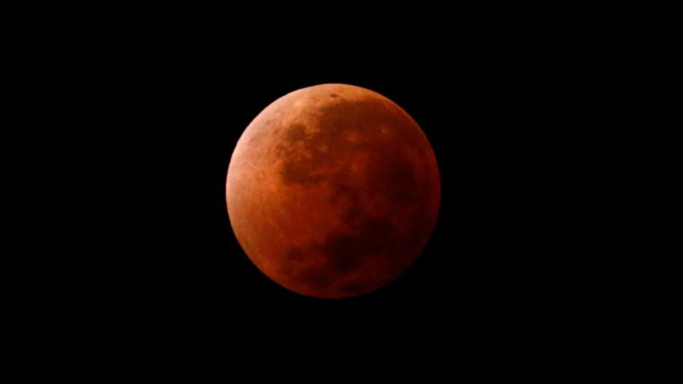 The moon is seen over Buenos Aires, Argentina, as it begins a total lunar eclipse that turned the moon red in some parts of the world this morning. Photgraph: Marcos Brindicci/Reuters.