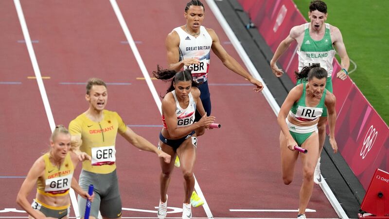 Ireland’s Phil Healy (right) receives the baton from Cillin Greene during the 4x400 metres mixed relay final in Tokyo. Photograph:  Martin Rickett/PA Wire