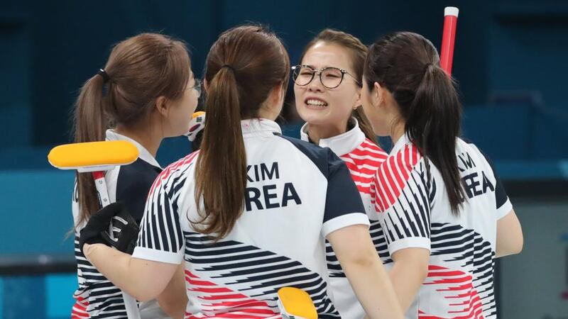 Skip Kim Eun-Jung (centre) of South Korea and team-mates console each other after losing the women’s curling gold medal match against Sweden. Photograph: Yonhap/EPA