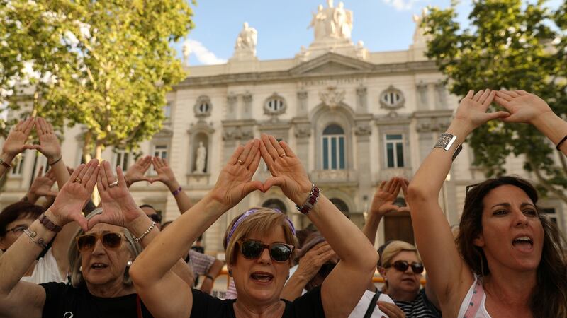 Women gather outside the Supreme Court in Madrid after Spain’s top court found five men known as the ‘Wolf Pack’ guilty of rape. Photograph: Susana Vera/Reuters