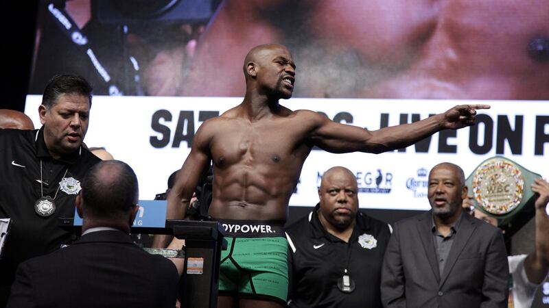 Boxer Floyd Mayweather Jr gestures towards Conor McGregor during their weigh-in at the T-Mobile Arena in Las Vegas on August 25th, 2017. The former welterweight boxing champion defeated the MMA fighter in a 10th-round technical knockout. Photograph: John Gurzinski/AFP/Getty