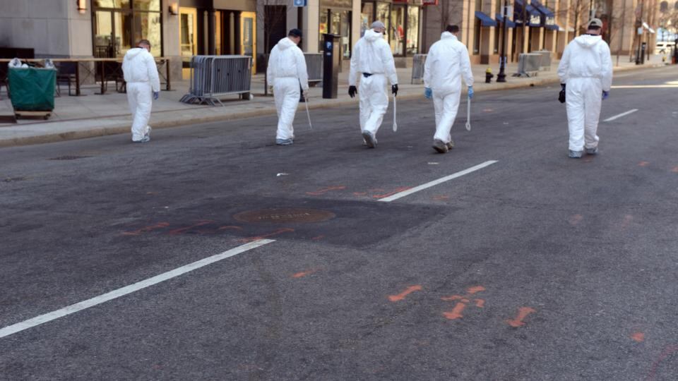 Investigators continue to work the scene of two bomb explosions at the finish line of the marathon that killed 3 people and injured over one hundred more. Photograph: Darren McCollester/Getty Images