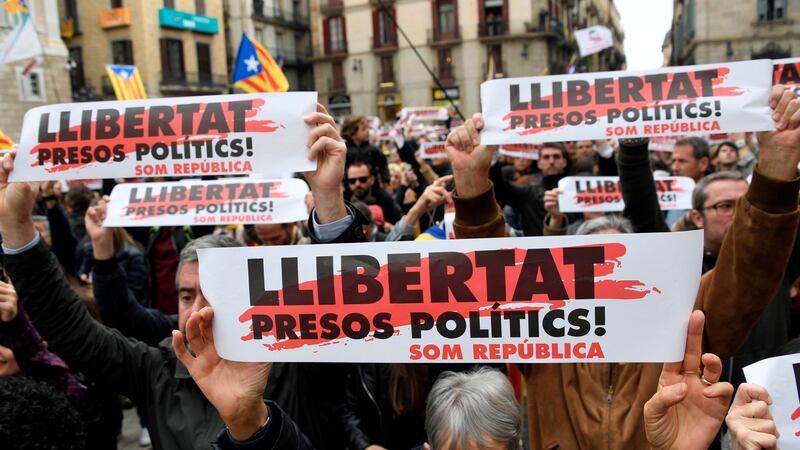 People hold placards reading ‘Free political prisoners’ during a demonstration outside the Generalitat Palace in Barcelona Wednesday during a regionwide strike called by a pro-independence union. Photograph: Gabriel Bouys/AFP/Getty Images