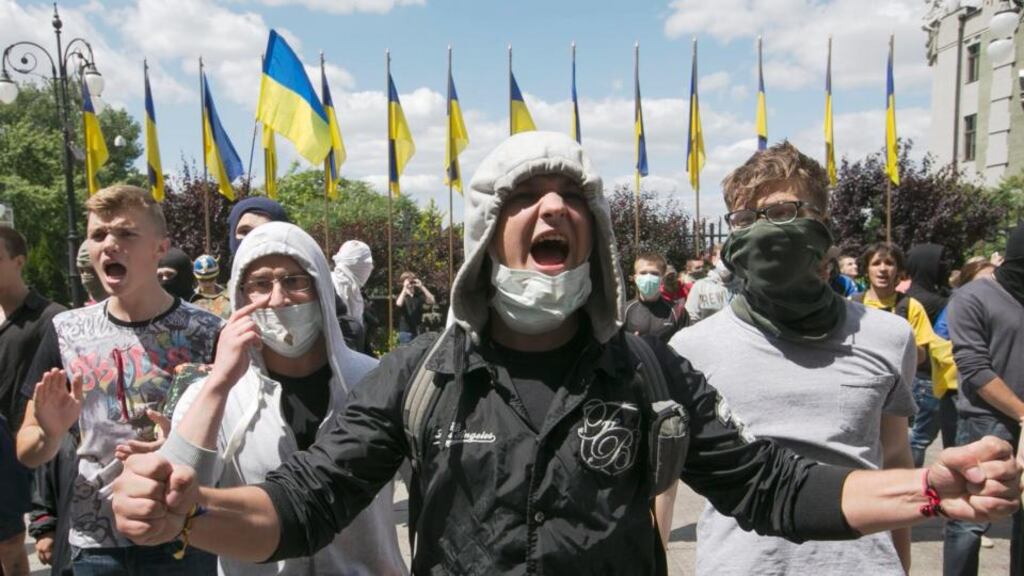 Masked Ukrainian nationalists demand immediate continue of the anti-terrorist operation in front of the presidential administration office in Kiev, Ukraine today. Photograph: Sergei Chirikov/EPA