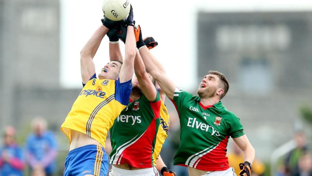 Mayo’s Aidan O’Shea and Séamus O’Shea contest an aerial ball with Cathal Shine and Kevin Higgins of Roscommon. Photo: James Crombie/Inpho