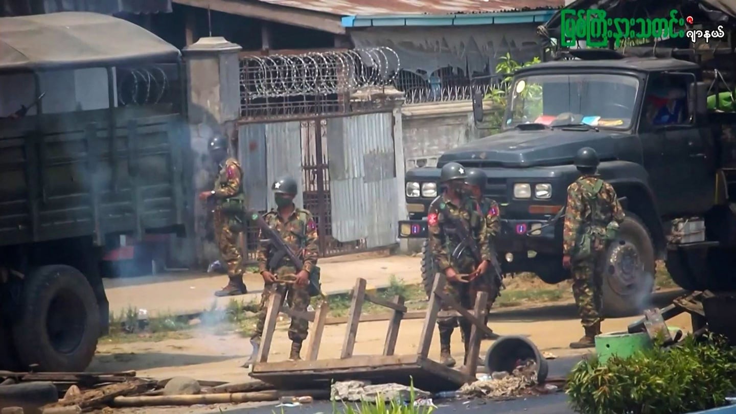 Soldiers stand guard next to a makeshift barricade made by protesters during a crackdown by security forces on a demonstration against the military coup in Myitkyina, Myanmar. Photograph: AFPTV/AFP via Getty