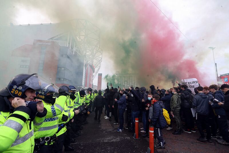 Manchester United fans outside the ground with police presence during a protest against the Glazer family, the owners of Manchester United, ahead of their Premier League match against Liverpool at Old Trafford. Photo: Martin Rickett/PA Wire.