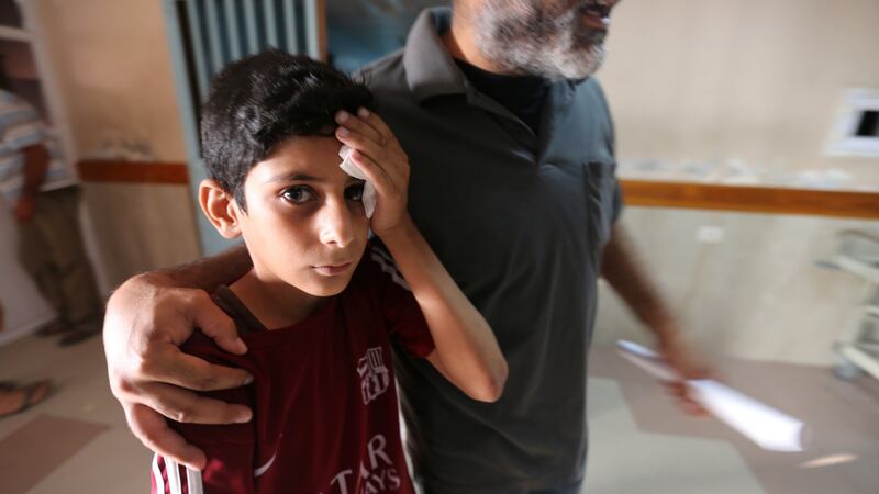 A wounded Palestinian boy is brought into the hospital following Israeli air strikes in Gaza City July 14th, 2018. Photograph: REUTERS/Ibraheem Abu Mustafa