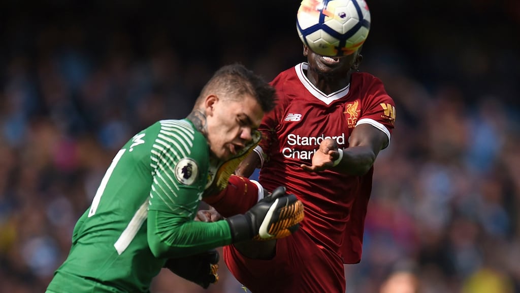 Liverpool midfielder Sadio Mane challenges Manchester City goalkeeper Ederson, which led to his sending off. Photograph: Oli Scarff/AFP/Getty Images