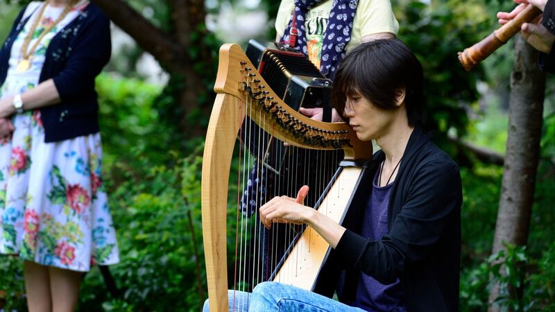 Junshi Morakami played the Irish Harp during the annual commemoration for the victims of the Hiroshima atomic bomb at the memorial cherry tree at Merrion Sq. Photograph: Cyril Byrne/The Irish Times