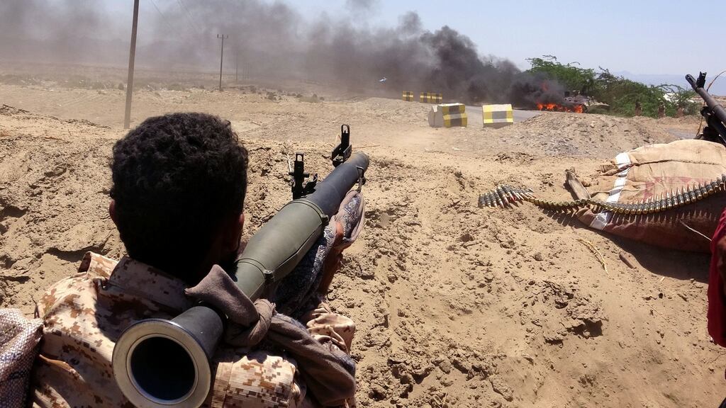 A fighter of the Southern Transitional Council  watches as a military vehicle belonging to Saudi-backed government forces burns during clashes in the southern Abyan province of Yemen. Photograph:  AFP via Getty Images