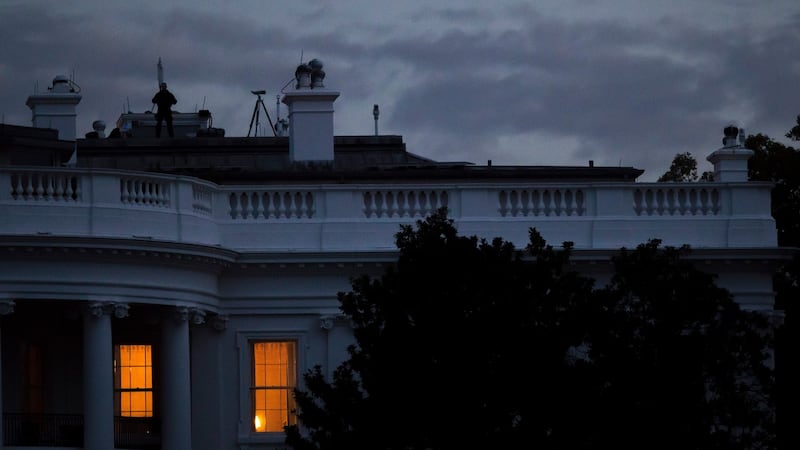 Lights on at daybreak in the South Portico of the White House in Washington. President Donald Trump is often up around 5.30 each morning, tuned into the television in the master bedroom. Photograph: Tom Brenner/The New York Times
