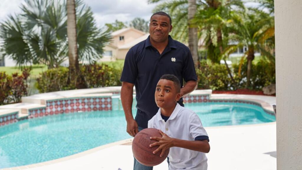 Shawn Wooden, a former Miami Dolphins player and important advocate of the concussion settlement with the NFL, with his son, Shane, at home in Pembroke Pines. Photograph: Ryan Stone/The New York Times