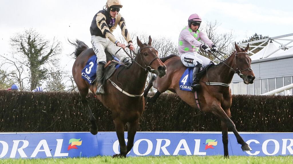 David Mullins on Bellshill (left0 clears the last ahead of Patrick Mullins on Djakadam on the way to winning the  Coral Punchestown Gold Cup. Photograph:  James Crombie/Inpho