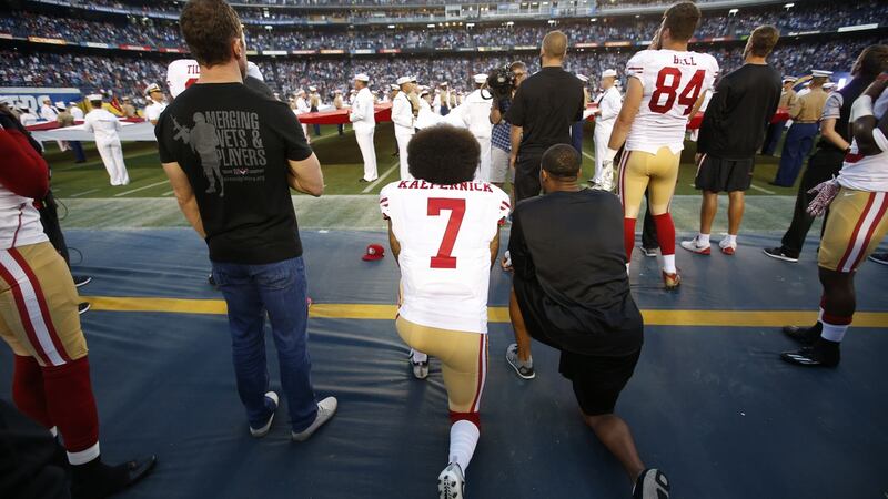 Colin Kaepernick and Eric Reid of the San Francisco 49ers kneel during the playing of the anthem before the game against the San Diego Chargers in September 2016. Photograph: Michael Zagaris/San Francisco 49ers/Getty Images