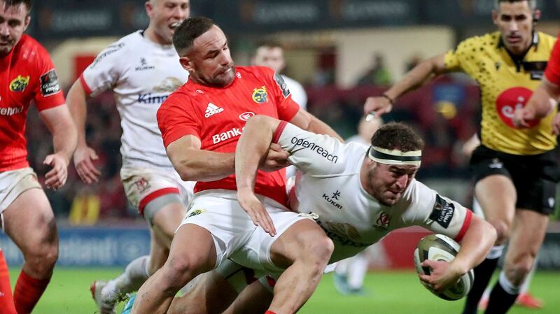 Ulster’s Rob Herring on his way to scoring a try despite the efforts of Alby Mathewson of Munster during the Guinness Pro 14 game at Thomond Park. Photograph: Bryan Keane/Inpho