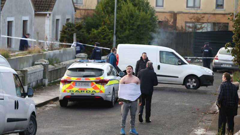 A man reacts at Parslickstown Gardens in Blanchardstown, west Dublin, near the scene where a young child and a teenager were injured in a shooting incident. Photograph: Niall Carson/PA Wire