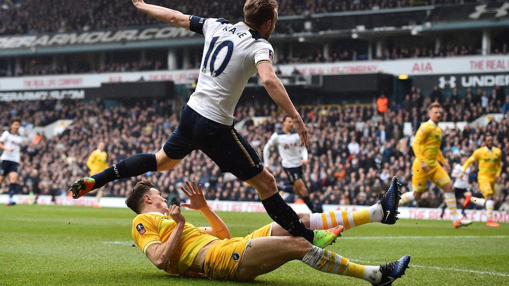 Harry Kane suffered an ankle injury in this tackle by Millwall’s Jake Cooper during the FA Cup quarter-final at White Hart Lane. Photograph: Glyn Kirk/AFP/Getty Images