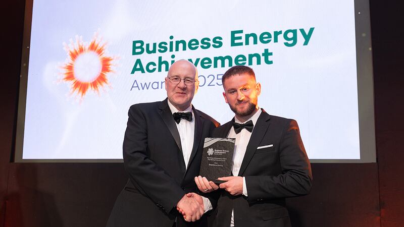 Michael Conlon, awards judge, presents the best energy achievement in FMCG to Adam Kane, community lead at BusinessRiver on behalf of Ballykilcavan Brewing