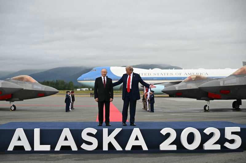 Donald Trump and Vladimir Putin briefly posed on a stage marked "Alaska 2025" after meeting at the air base. Photograph: Andrew Caballero-Reynolds/AFP/Getty